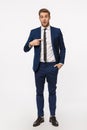 Who me, you mean I. Surprised and curious young clueless blond businessman in classic suit, pointing himself and asking Royalty Free Stock Photo