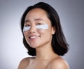 Who wants puffy eyes. a young woman wearing an eye mask against a grey background. Royalty Free Stock Photo