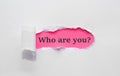 Who are you question written under torn paper