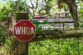 Whoa sign shaped like a stop sign, on fence in front of horse ranch - Davie, Florida, USA