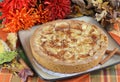 Whole apple kuchen cake in fall setting. Royalty Free Stock Photo