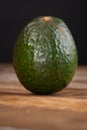 Whole avocado on wooden table