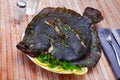 Baked brill fish with lemon and greens