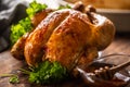 Whole baked chicken with crusty skin glazed with honey on top and parsley on the side Royalty Free Stock Photo