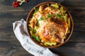 Whole baked chicken with mushrooms and potatoes close-up in a baking dish on a table. horizontal top view from above. Baked turkey Royalty Free Stock Photo