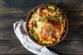 Whole baked chicken with mushrooms and potatoes close-up in a baking dish on a table. horizontal top view from above. Baked turkey Royalty Free Stock Photo