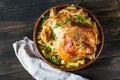 Whole baked chicken with mushrooms and potatoes close-up in a baking dish on a table. horizontal top view from above. Baked turkey Royalty Free Stock Photo