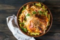 Whole baked chicken with mushrooms and potatoes close-up in a baking dish on a table. horizontal top view from above. Baked turkey Royalty Free Stock Photo