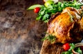 Whole baked chicken with mushrooms and potatoes close-up in a baking dish on a table. horizontal top view from above. Royalty Free Stock Photo