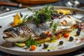 Whole Baked Rainbow Trout, Fried Trout Fish on a Vegetable Pillow with Creamy Caviar Sauce Royalty Free Stock Photo