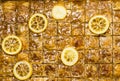 Whole baklava with lemon on a making texture