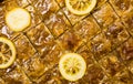 Whole baklava with lemon on a making texture