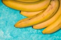 Whole bananas on a turquoise background free space Royalty Free Stock Photo