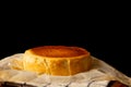 Whole Basque burnt cheesecake isolated on wooden table. Royalty Free Stock Photo