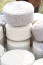 Whole big wheels of natural wool rolls used for the production of woolen socks Royalty Free Stock Photo