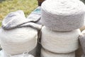 Whole big wheels of natural wool rolls used for the production of woolen socks Royalty Free Stock Photo