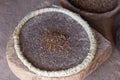 Whole black sage seed on grinding stone