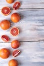 Whole blood oranges and slices on a white wooden background, top view Royalty Free Stock Photo