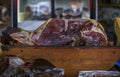 Whole bone-in ham leg of Montenegrin Njeguski prsut cured ham and sliced packaged meat at a market in Kotor Montenegro