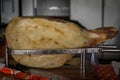 Whole bone-in ham leg of Montenegrin Njeguski prsut cured ham and sliced packaged meat at a market in Kotor Montenegro