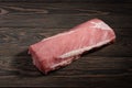 Whole boneless pork loin without fat. Pork tenderloin on a dark background Royalty Free Stock Photo