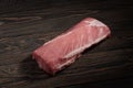 Whole boneless pork loin without fat. Pork tenderloin on a dark background Royalty Free Stock Photo