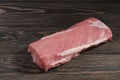 Whole boneless pork loin without fat. Pork tenderloin on a dark background Royalty Free Stock Photo