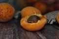 whole broken apricot on a dark table
