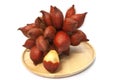 Whole bunch of Salacca zalacca or salak fruit in wooden plate. Royalty Free Stock Photo