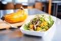 whole butternut squash beside a colorful roasted squash salad