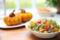 whole butternut squash beside a colorful roasted squash salad