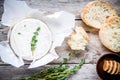 Whole Camembert cheese with thyme, honey and baguette