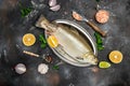 Whole carcass of the fresh uncooked arctic char on a metal tray on a dark background, banner, menu, recipe place for text, top Royalty Free Stock Photo