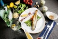 whole carcass of sea trout on the grill. Fried red fish with vegetables and sauce. Close-up. Concept - food  delicacies Royalty Free Stock Photo