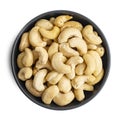 Whole cashews in dark bowl isolated on white background. Top view Royalty Free Stock Photo