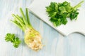 Whole celery on a white cutting board