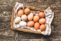 Whole chicken eggs in basket on wooden table. Top view Royalty Free Stock Photo