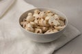 Whole and chopped mushrooms in a round porcelain bowl on a white towel Royalty Free Stock Photo