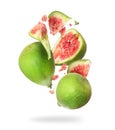 Whole and chopped ripe green figs in the air, isolated on white background Royalty Free Stock Photo