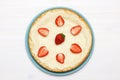 A whole classic cheesecake with strawberries on a white background. Top view Royalty Free Stock Photo