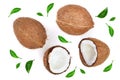 Whole coconut with half decorated with leaves isolated on white background. Flat lay. Top view Royalty Free Stock Photo