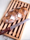 Whole country loaf on a cutting board with a bread knife Royalty Free Stock Photo