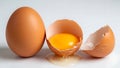 Whole and Cracked Brown Eggs with Yolk on White Background Royalty Free Stock Photo
