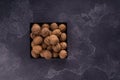 Whole and cracked walnuts on a square plate on blue textured surface, top view. Healthy nuts and seeds composition. Royalty Free Stock Photo