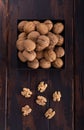 Whole and cracked walnuts on a square plate on wooden table, top view. Healthy nuts and seeds composition. Royalty Free Stock Photo
