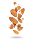 Whole and crushed almonds close-up in the air on a white background Royalty Free Stock Photo