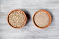 Whole and crushed rye grains in ceramic bowls Royalty Free Stock Photo