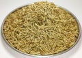 Whole cumin seeds isolate white background.