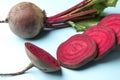 Whole and cut fresh red beets on light blue background, closeup Royalty Free Stock Photo