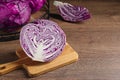 Whole and cut fresh red cabbage on wooden table, space for text Royalty Free Stock Photo